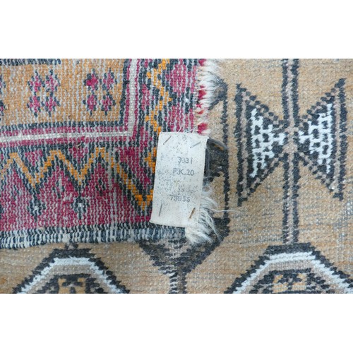 311C - A Distressed Afghan Style Prayer Rug. Wear and fraying noted. Length: 138cm Width: 90cm