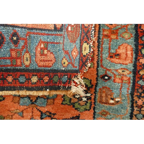 311E - An Eastern Rug with Two Medallion Pattern in Red and Turquoise Colours. Wear and fraying noted. Leng... 