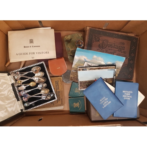 59 - A mixed collection of items to include stamp albums, commemorative coins and coin sets, collectors s... 