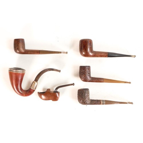 601 - A carved smokers stand together with five pipes, Dunhill Estate pipe noted. Height of stand: 19cm (6... 