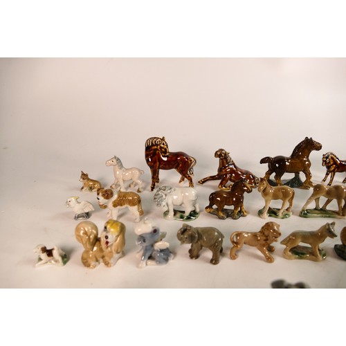 303 - A good collection of Wade Whimsies comprising Disney and first version Whimsies including Merlin as ... 