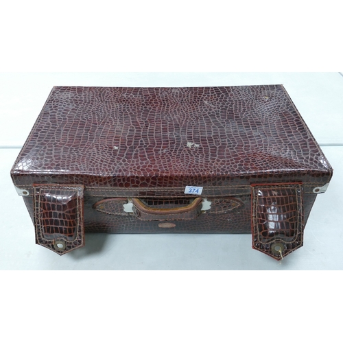 374 - A Large Faux Crocodile Skin Suitcase. Partial Label to interior reads Singapore. Rust and Tarnish to... 