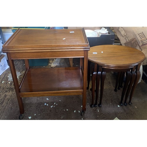 577 - Mid-century tea trolley on castors together with a nest of 3 oval occasional tables.