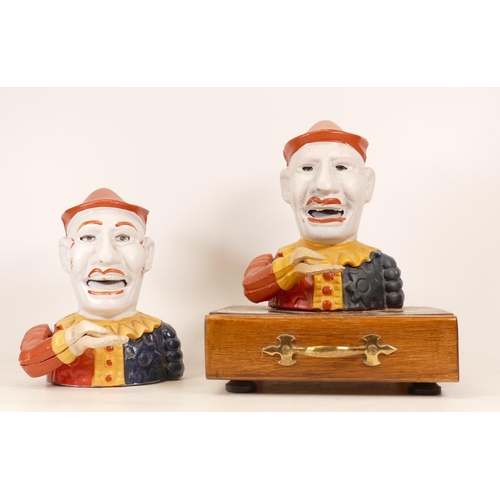 557 - Two Painted Cast Iron Money Boxes of Jesters/Clowns. One mounted on a wood and brass base (detached ... 