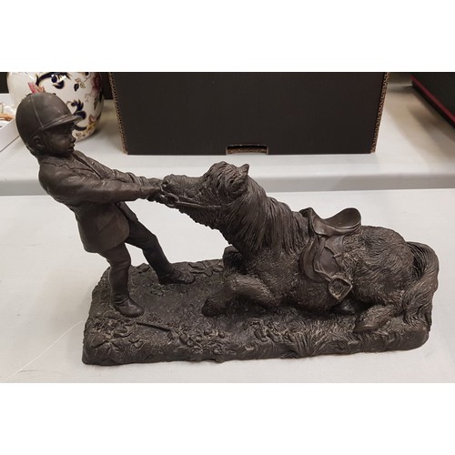 465 - Heredities bronzed resin figure depicting a boy and pony, length 33cm.