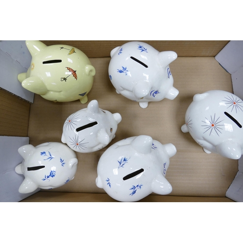 44 - A collection of Wade money boxes to include floral piggy banks (1 tray)