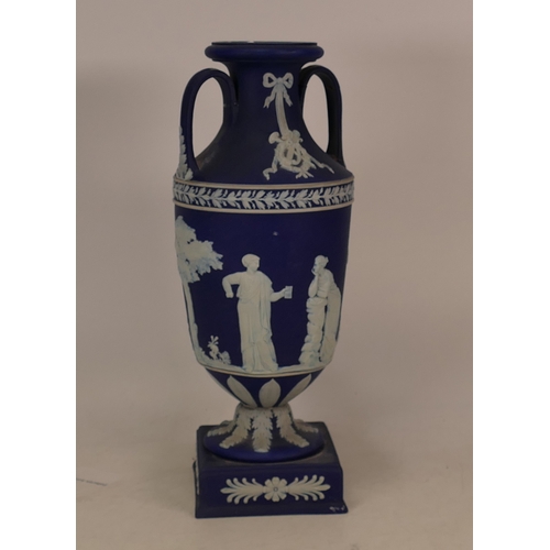 143 - Wedgwood dip blue twin handled vase on base with classical scenes (handles a/f)