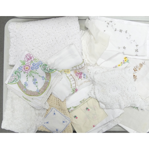 140 - A collection of lace and embroidered table cloths, doilies, head rests together with a fur muff