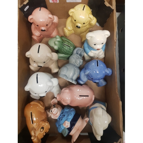 306 - A collection of Wade Teddy bear money boxes together with Natwest pig, frog, rabbit and cow examples... 