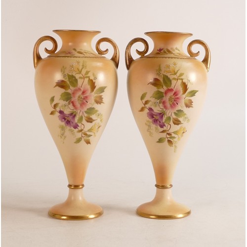 127 - A pair of Carlton ware Wiltshaw & Robinson Ivory Blush ware twin handled vases in the Hibiscus patte... 