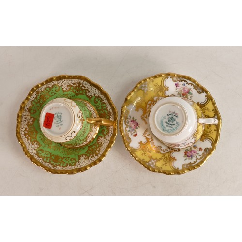 221 - Two Coalport cups & saucers, one yellow and gilt with floral border the other green and gilt.(4)