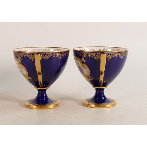 491 - A pair of Royal Worcester hand painted twin handled vases. Cobalt blue ground with Rococo cartouche ... 