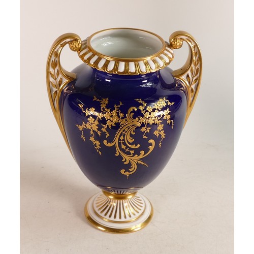 492 - A Royal Worcester hand painted twin handled vase. Painted with Orchid vignettes signed by Roberts. H... 