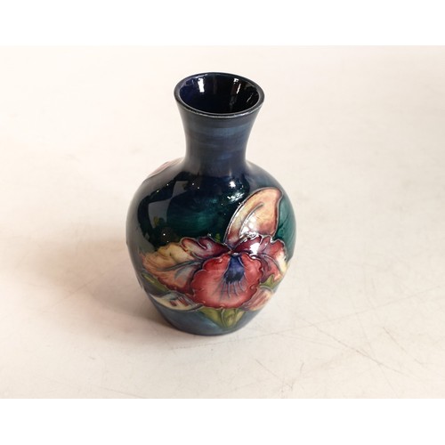 504 - Moorcroft Orchid pattern small vase of bottle form. Height: 9.3cm