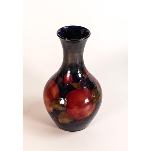 597 - William Moorcroft vase decorated in the Pomegranate. c1920, h.21cm.