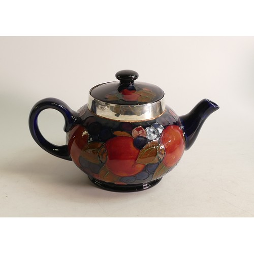 660 - William Moorcroft Pomegranate tea pot, signed. Sterling silver collar replacement. Height 12.5cm