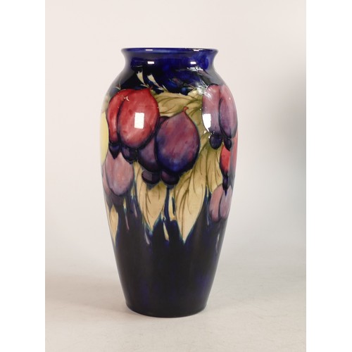 682 - Moorcroft Wisteria vase on blue ground. Impressed marks to base. Height 25cm