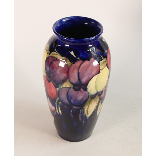 682 - Moorcroft Wisteria vase on blue ground. Impressed marks to base. Height 25cm