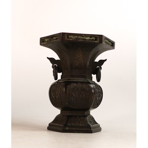 1657 - A Chinese Bronze octagonal form vase decorated with repeating pairs of Mythical Birds. Height: 12cm