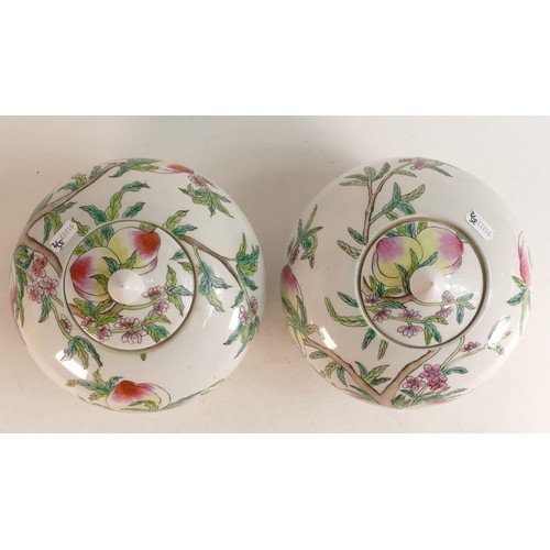 1662 - Two oriental lidded porcelain jars with painted decoration of Peaches. Height: 20cm (2)