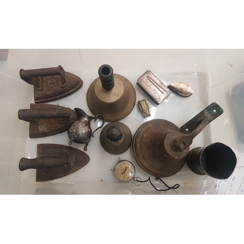 468 - A mixed collection of metalware items to include cast iron flat irons, bronze and brass bells, silve... 