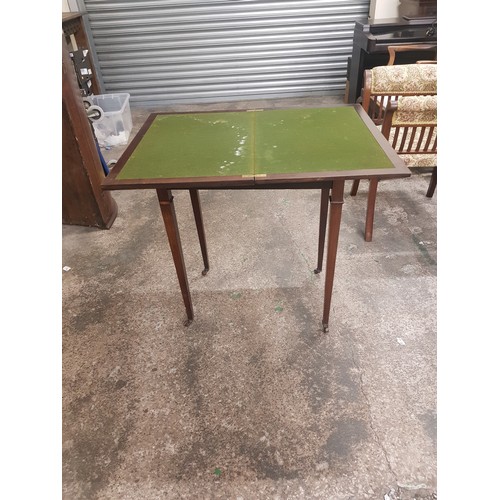 617 - Mahogany fold over card table on brass castors