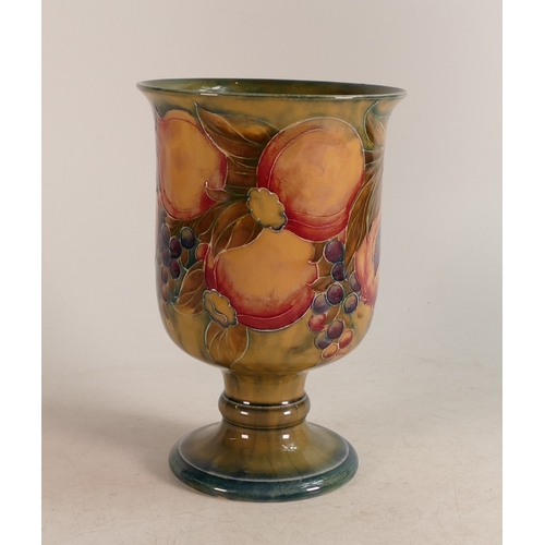 695 - William Moorcroft chalice, c1911, decorated in the pomegranate design on Ochre ground. h.20.5cm. Chi... 