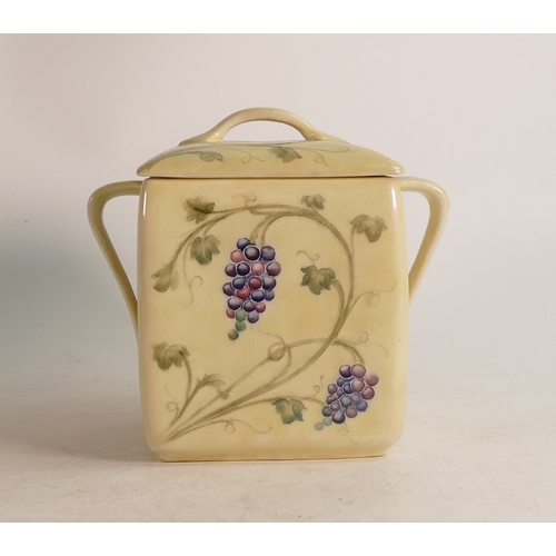 700 - William Moorcroft lustre two handled biscuit barrel & cover, in the Arts & Crafts Grape & Vine desig... 