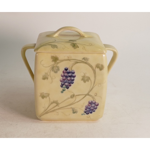 700 - William Moorcroft lustre two handled biscuit barrel & cover, in the Arts & Crafts Grape & Vine desig... 