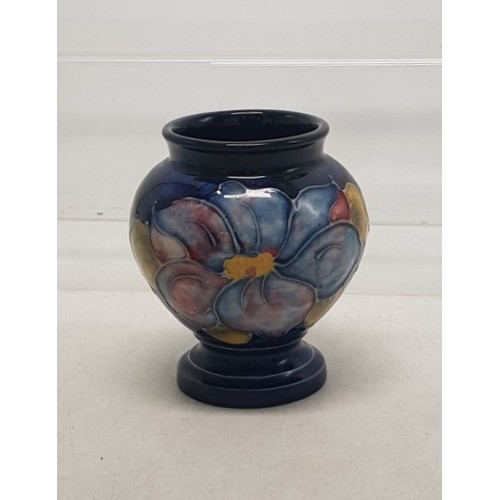 528 - Moorcroft Footed Vase in the Clematis Pattern on Cobalt Blue Ground. Height 9cm.