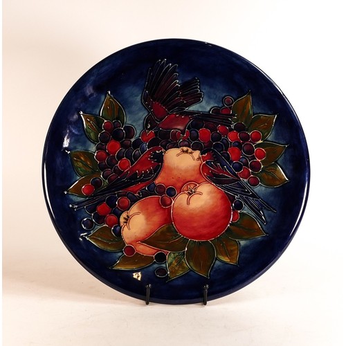 683 - Moorcroft large charger decorated in the Finch and Berries design on dark blue ground, c1990, d.35cm... 