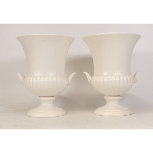 266 - A Pair of Wedgwood Cream Urns, Moulded with Shell Handles. Height: 17cm (2)