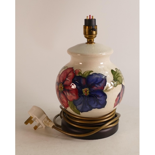 256 - Moorcroft Clematis patterned lamp base on wooden plinth. height including fitting 26cm