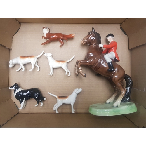 142 - Beswick Rearing Huntsman 868 (tail a/f), together with a small fox and 3 foxhounds and a border coll... 