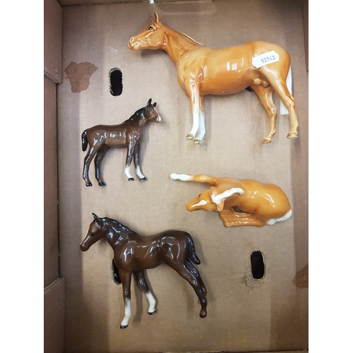 218 - A collection of Beswick horses and foals to include a palomino stallion, palomino lying foal and 2 b... 