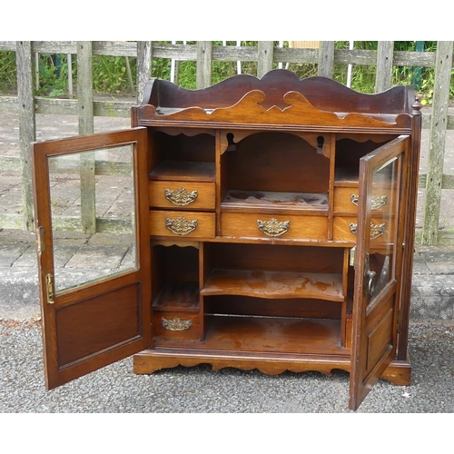 610 - A large smokers cabinet with glass front doors. One finial missing. Height: 61.5cm Width: 55cm