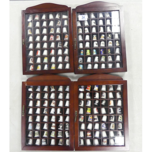 34 - A collection of thimbles to include animal themes, advertising, TV shows, etc (4)