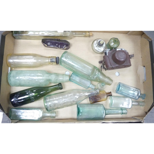 70 - A mixed collection of items to include glass bottles including some advertising James Davis, Camp co... 