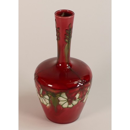 171 - Minton Secessionist bottle vase. Decorated with tube lined flowers on red ground. No. 32. Height: 17... 