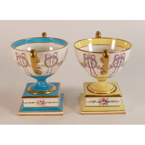 173 - Minton, two bow garland pattern pedestal vases. One on Celeste bleu (hairline crack noted), the othe... 