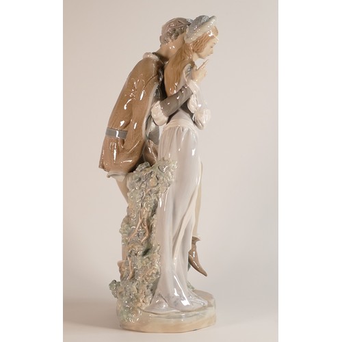 201 - Lladro Romeo & Juliet. An excellent figure group with Romeo sat on a wall embracing Juliet. In origi... 