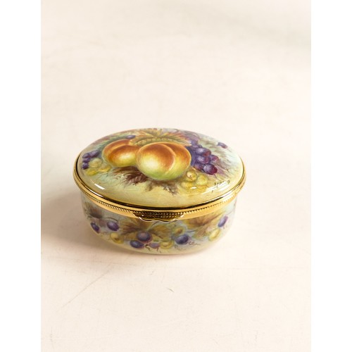 211 - Moorcroft enamel Fruit oval lidded box by Nigel Creed. Boxed, length 6.5cm