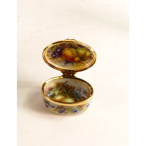 211 - Moorcroft enamel Fruit oval lidded box by Nigel Creed. Boxed, length 6.5cm