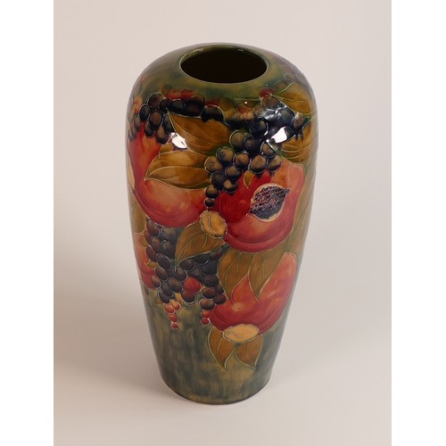 275 - William Moorcroft vase decorated in the Pomegranate design on ochre ground, signed W Moorcroft in gr... 