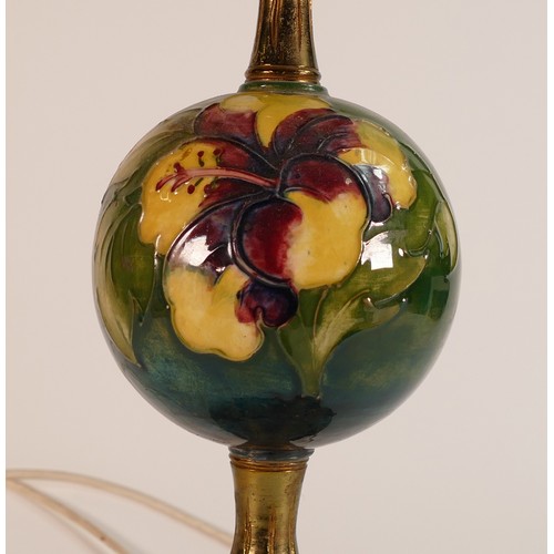 294 - Moorcroft Hibiscus on green ground lamp of unusual form with globular ceramic centre. Ormolu brass f... 