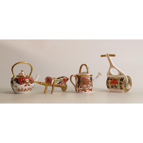 378 - A Royal Crown Derby Imari miniature model Garden Roller together with Watering Can, Wheelbarrow and ... 