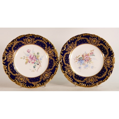 379 - Two Royal Crown Derby hand painted floral plates with cobalt blue border with gilt and enamelled dec... 