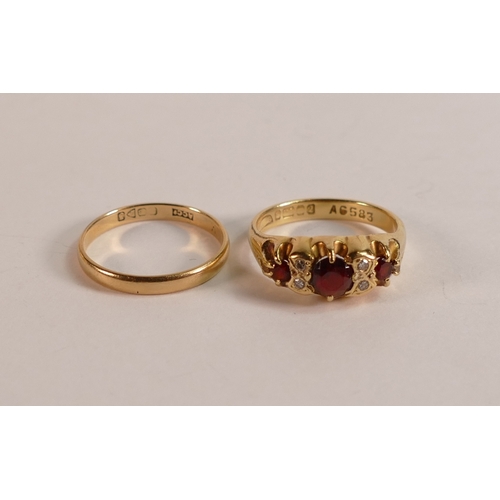 723 - 18ct gold ring set with rubies/garnet stones, size O, 5.2g and 18ct gold wedding ring, 1.9g. (2)