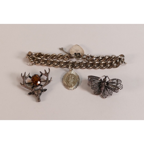 732 - Silver bracelet with heart shaped locket, 33.7g, silver butterfly brooch, 4.1g and Silver stags head... 