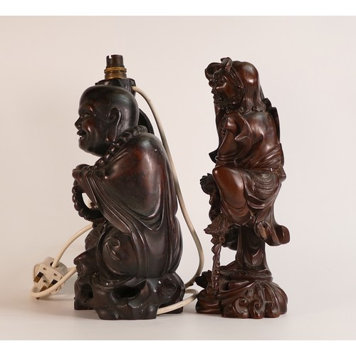 78 - Two Oriental hardwood figures, including Monk lamp and an Immortal figure atop a turtle. Height of t... 